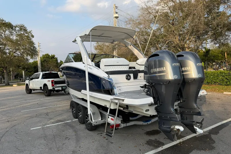 Slide: The Image of 2019 Regal 29 OBX boat with dual Yamaha engines on a trailer in a parking lot. - 6