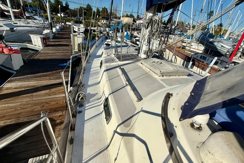 Slide: The Image of 1981 Mariner Mayflower sailboat docked at marina, showcasing deck and rigging. - 12