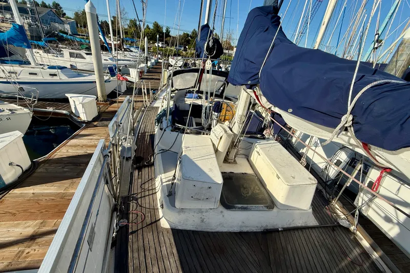 Slide: The Image of 1981 Mariner Mayflower sailboat docked at marina, featuring deck and rigging. - 14