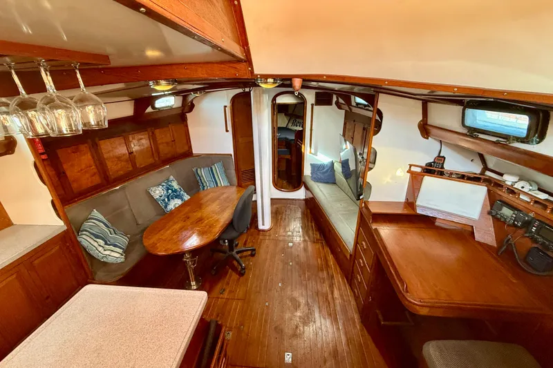 Slide: The Image of Interior of 1981 Mariner Mayflower yacht with wooden furnishings and cozy seating area. - 18