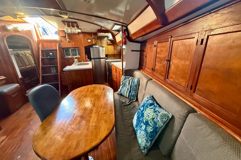 Slide: The Image of Interior of 1981 Mariner Mayflower yacht with wooden decor and cozy seating area. - 22
