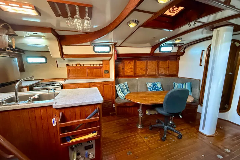 Slide: The Image of Interior of 1981 Mariner Mayflower yacht with wooden furnishings and cozy seating area. - 24