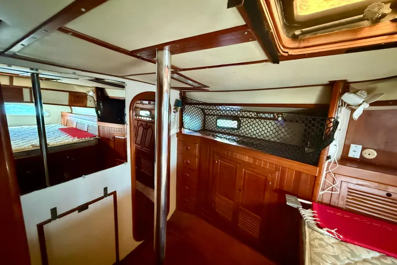 Slide: The Image of Interior of 1981 Mariner Mayflower boat with wood paneling and cozy sleeping area. - 29