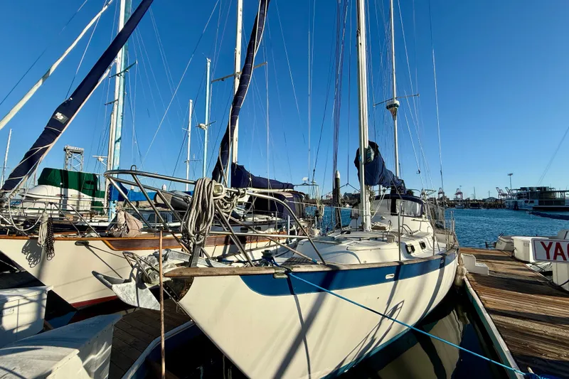 Slide: The Image of Sailboat docked at marina, Mariner Mayflower 1981, under clear blue sky. - 3