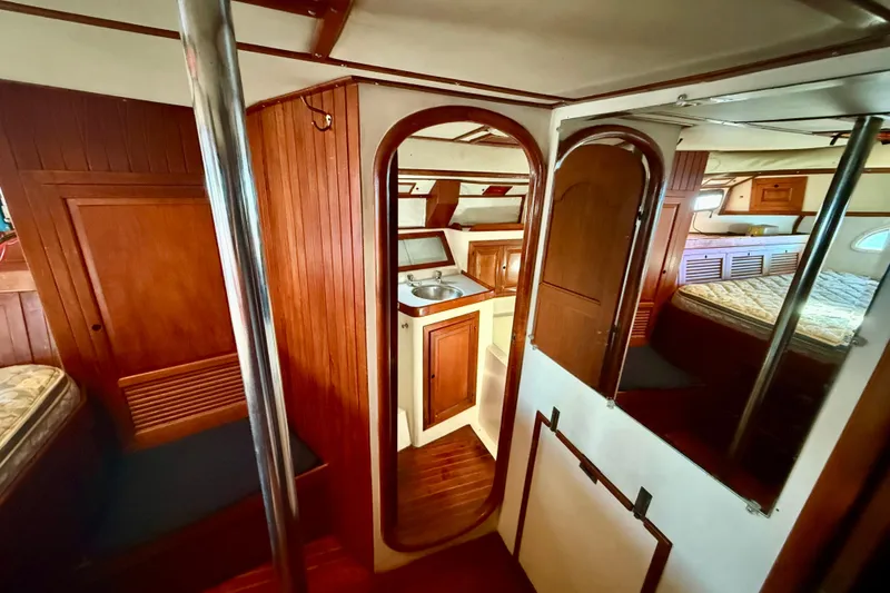 Slide: The Image of Interior of 1981 Mariner Mayflower yacht with wood paneling and compact kitchen area. - 31