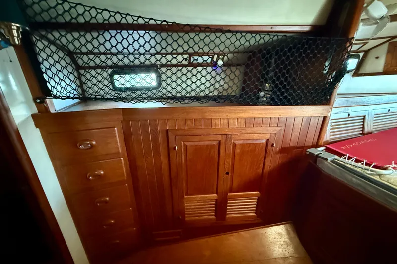 Slide: The Image of Interior of 1981 Mariner Mayflower boat with wooden cabinets and netting. - 32