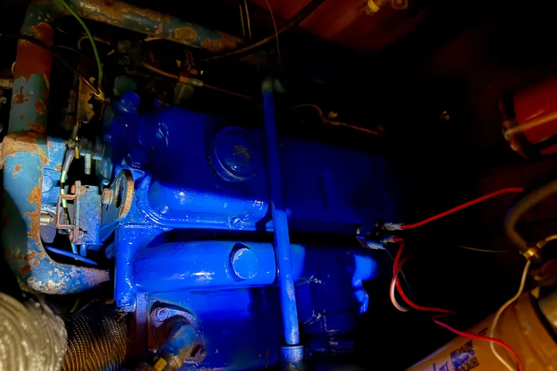 Slide: The Image of Blue engine of 1981 Mariner Mayflower with visible wiring and components. - 37