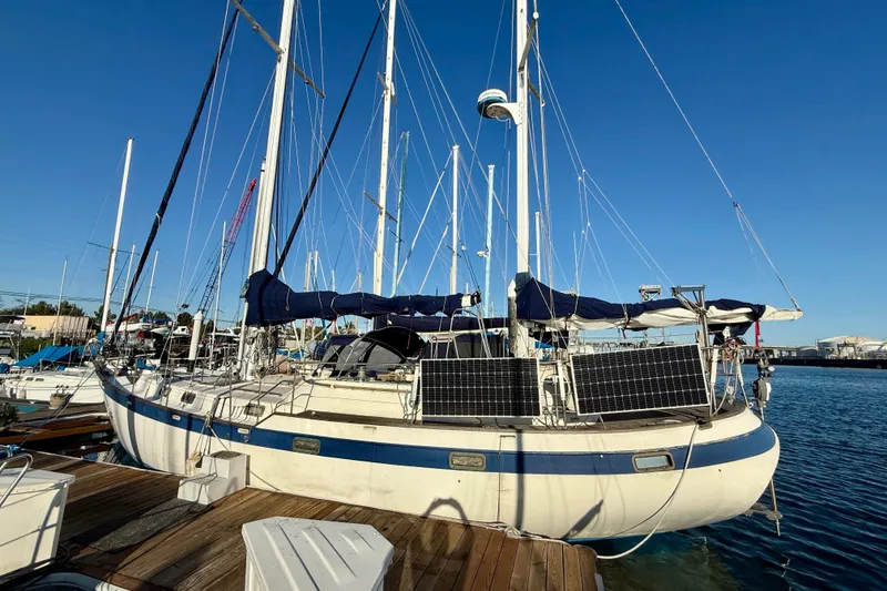 Slide: The Image of Sailboat docked at marina, Mariner Mayflower 1981, equipped with solar panels. - 5