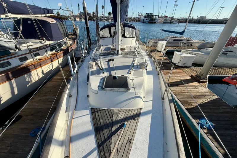 Slide: The Image of 1981 Mariner Mayflower sailboat docked at marina, surrounded by other boats. - 8