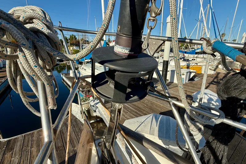 Slide: The Image of 1981 Mariner Mayflower sailboat deck with ropes and winch at marina. - 9