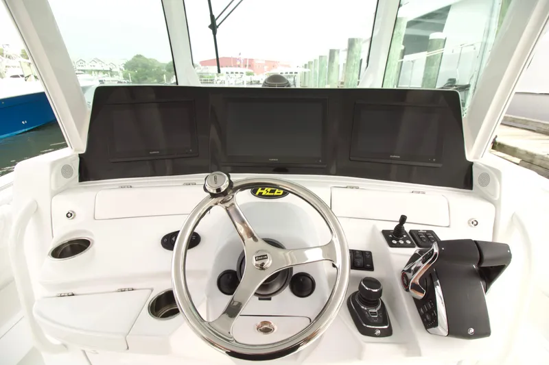 Slide: The Image of Helm of 2027 HCB 42 Lujo boat with modern controls and navigation screens. - 3