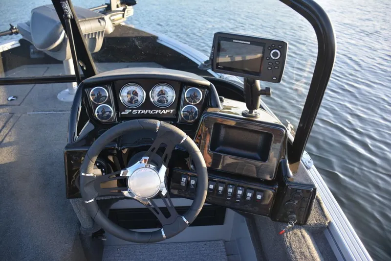 Slide: The Image of 2023 Starcraft Delta 178 SC Pro boat interior with steering wheel and control panel. - 10
