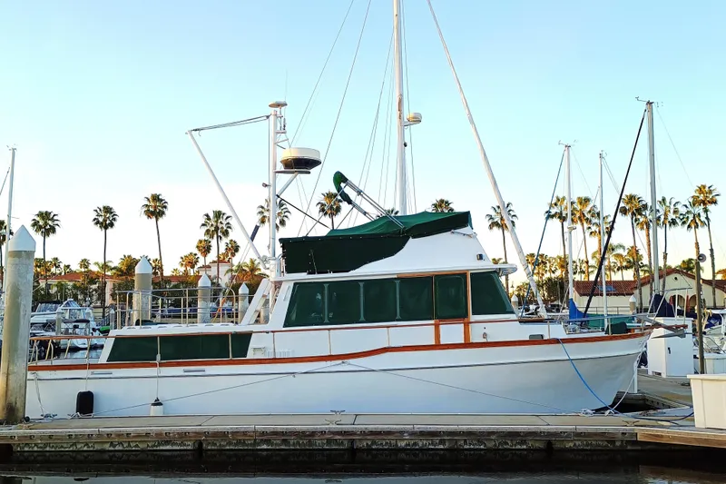 The Image of 1978 Californian LRC yacht docked at marina with palm trees in background. - 0