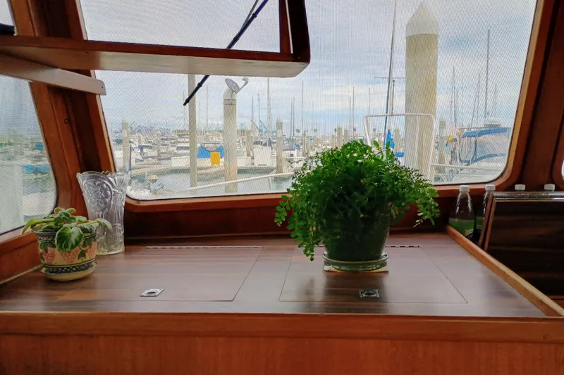 Slide: The Image of Interior of 1978 Californian LRC boat with plants and marina view. - 16