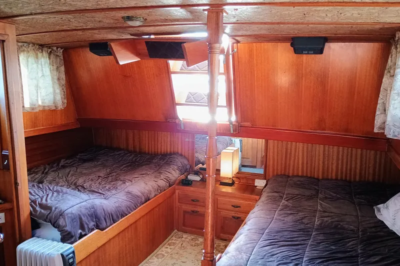 Slide: The Image of Cozy 1978 Californian LRC boat cabin with twin beds and wooden interior. - 29