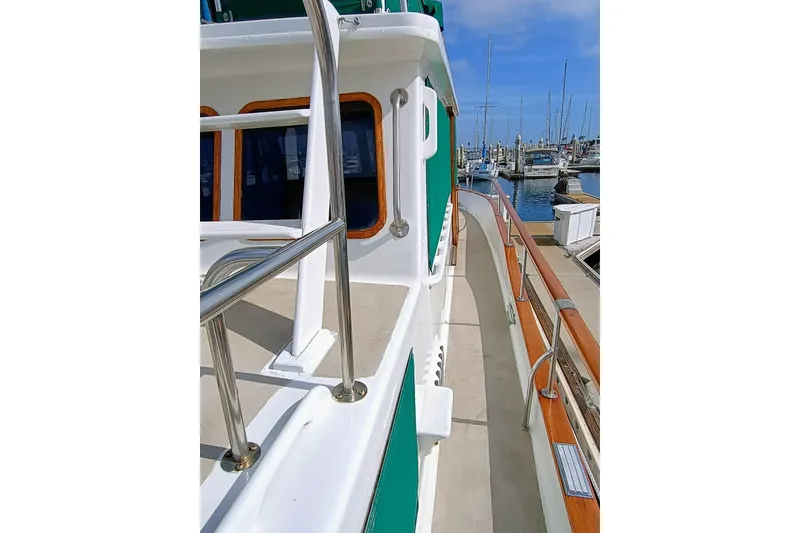 Slide: The Image of 1978 Californian LRC yacht deck with stainless steel railings, docked at marina. - 9