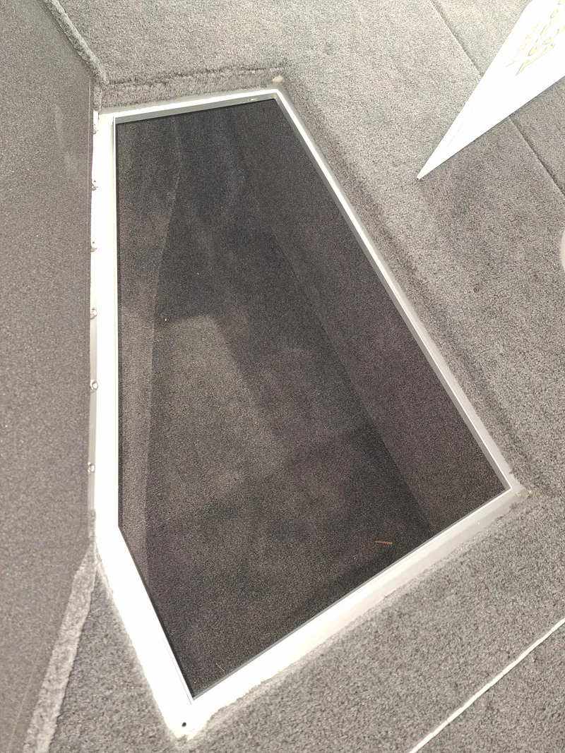 Slide: The Image of Storage compartment in 2025 Starcraft Delta 188 T boat, featuring carpeted interior. - 11