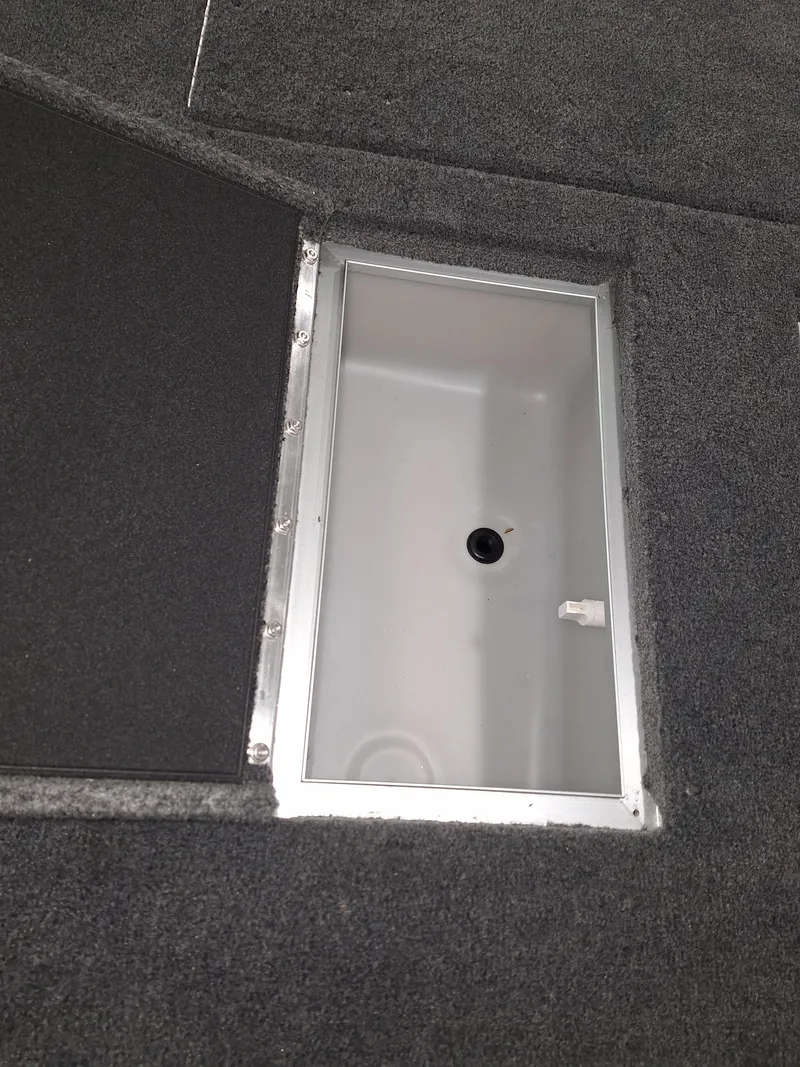 Slide: The Image of Starcraft Delta 188 T 2025 boat storage compartment with open hatch. - 12