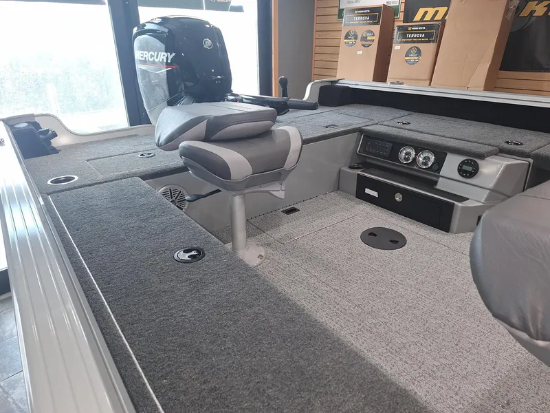 Slide: The Image of 2025 Starcraft Delta 188 T boat interior with Mercury engine, featuring gray seating and dashboard. - 14