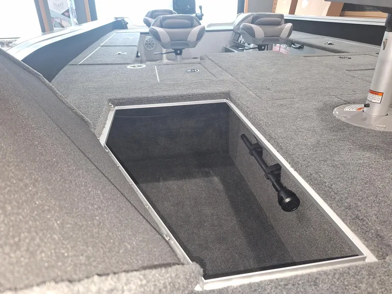 Slide: The Image of 2025 Starcraft Delta 188 T boat interior with open storage compartment and seating. - 18