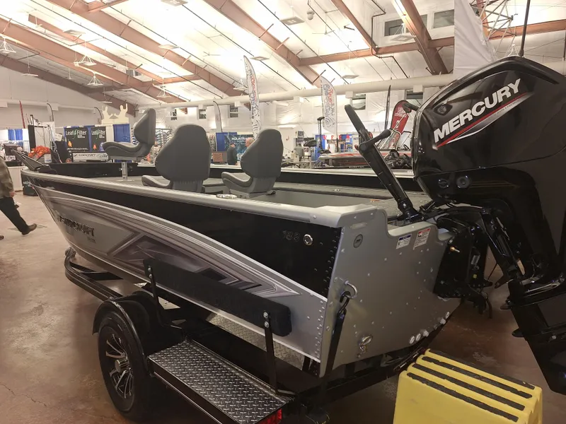 Slide: The Image of 2025 Starcraft Delta 188 T boat with Mercury engine displayed indoors. - 2