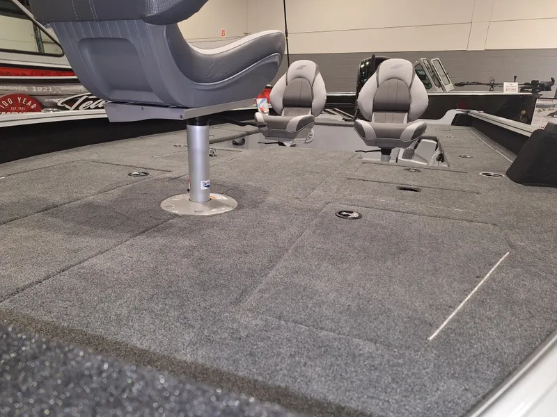 Slide: The Image of 2025 Starcraft Delta 188 T boat interior with gray seating and carpeted deck. - 4