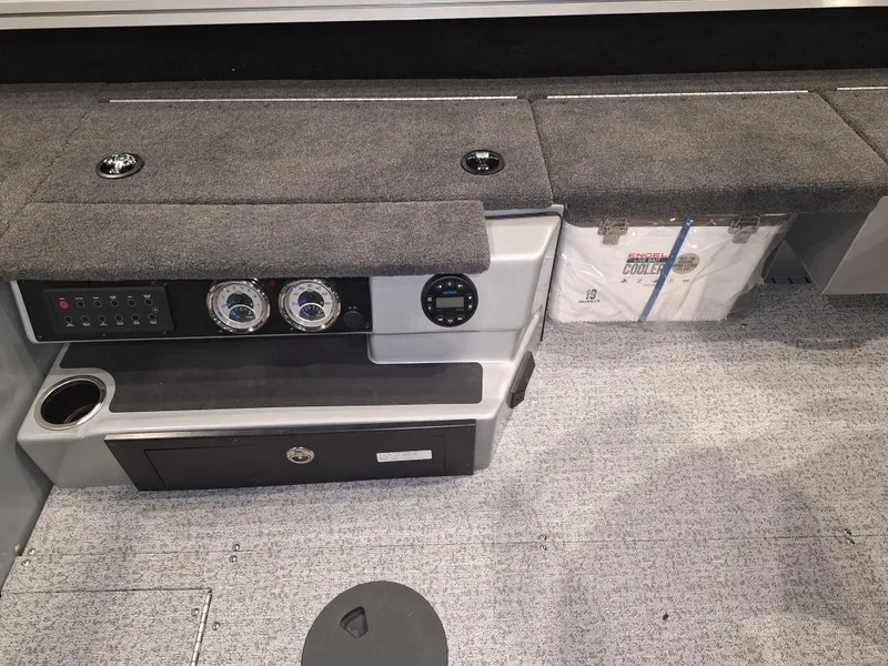 Slide: The Image of 2025 Starcraft Delta 188 T boat interior with control panel and storage compartments. - 7