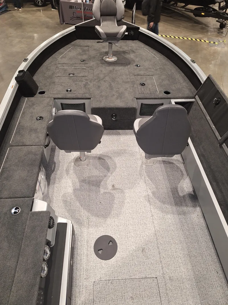 Slide: The Image of 2025 Starcraft Delta 188 T boat interior with gray seating and carpeted deck. - 9