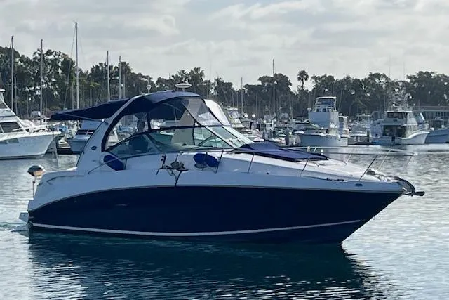 Slide: The Image of 2005 Searay 320 boat docked in a marina with other vessels. - 2