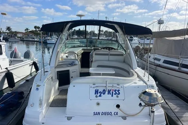 Slide: The Image of 2005 Searay 320 boat docked in San Diego marina under clear skies. - 3