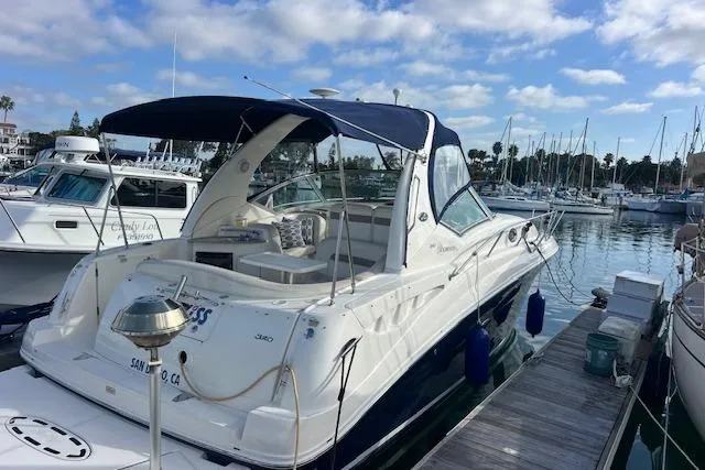 Slide: The Image of 2005 Searay 320 yacht docked at marina under blue sky. - 4