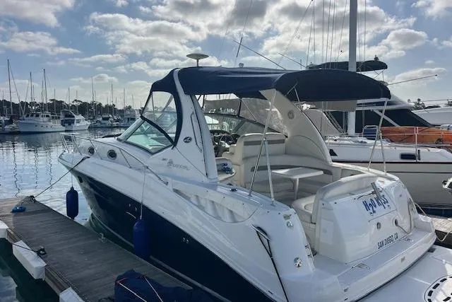 Slide: The Image of 2005 Searay 320 yacht docked at marina under cloudy sky. - 5