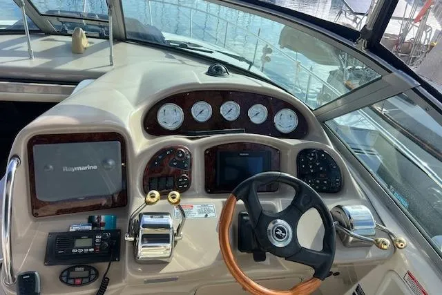 Slide: The Image of 2005 Searay 320 boat dashboard with steering wheel and navigation instruments. - 7