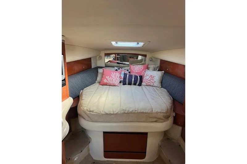 Slide: The Image of Interior cabin of a 2005 Searay 320 boat with cozy bedding and decorative pillows. - 8