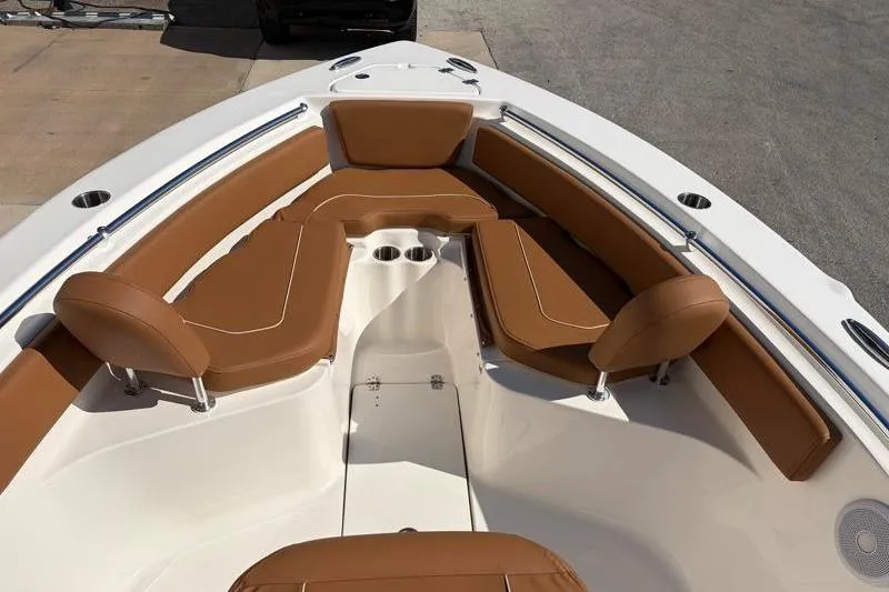Slide: The Image of 2025 Key West 239 FS boat interior with tan seating and cup holders. - 17