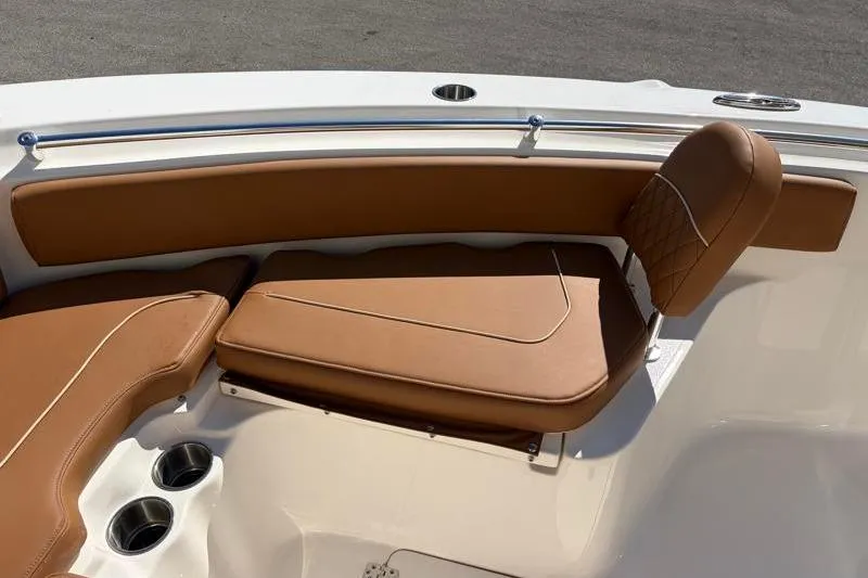 Slide: The Image of 2025 Key West 239 FS boat with tan leather seating and cup holders. - 18