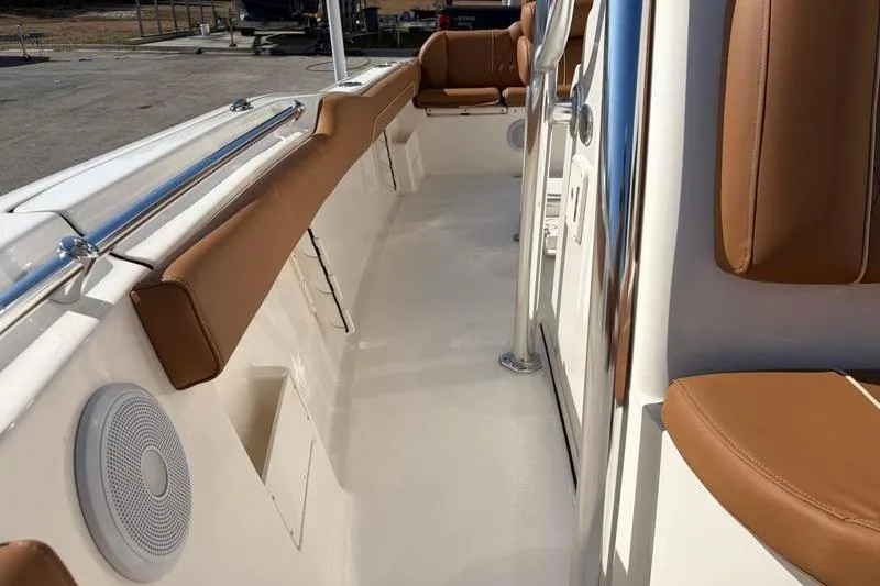 Slide: The Image of 2025 Key West 239 FS boat interior with tan seating and sleek design. - 23