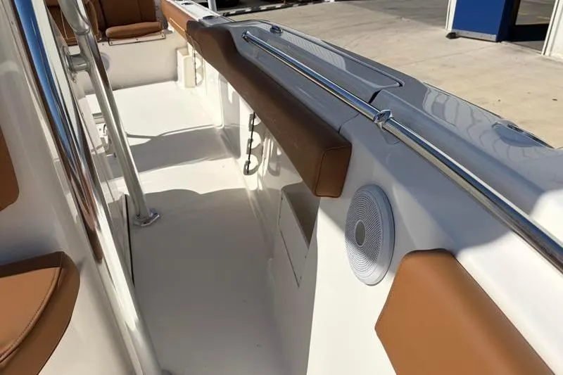 Slide: The Image of 2025 Key West 239 FS boat interior with brown seating and stainless steel railings. - 24