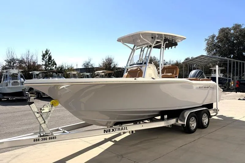 Slide: The Image of 2025 Key West 239 FS boat on trailer, parked outdoors under clear sky. - 3