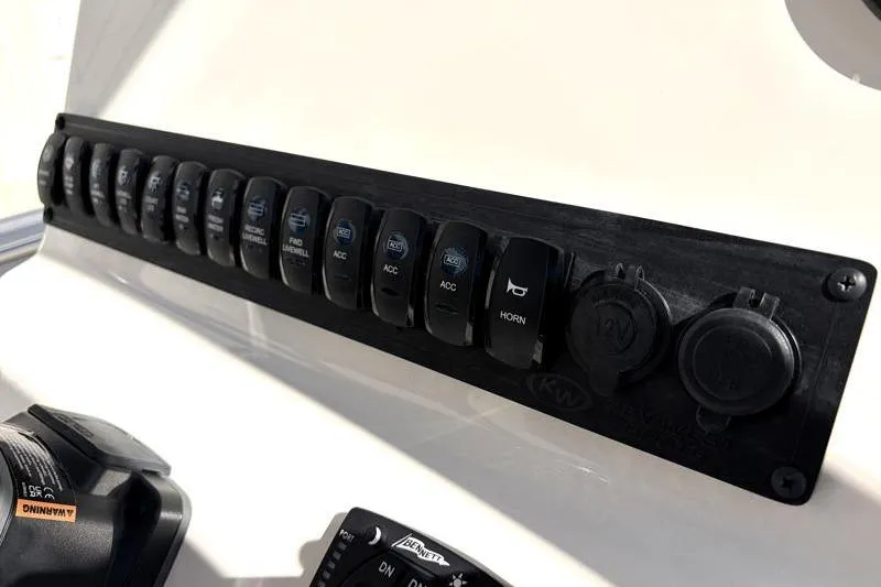 Slide: The Image of Control panel of 2025 Key West 239 FS boat with switches and outlets. - 30
