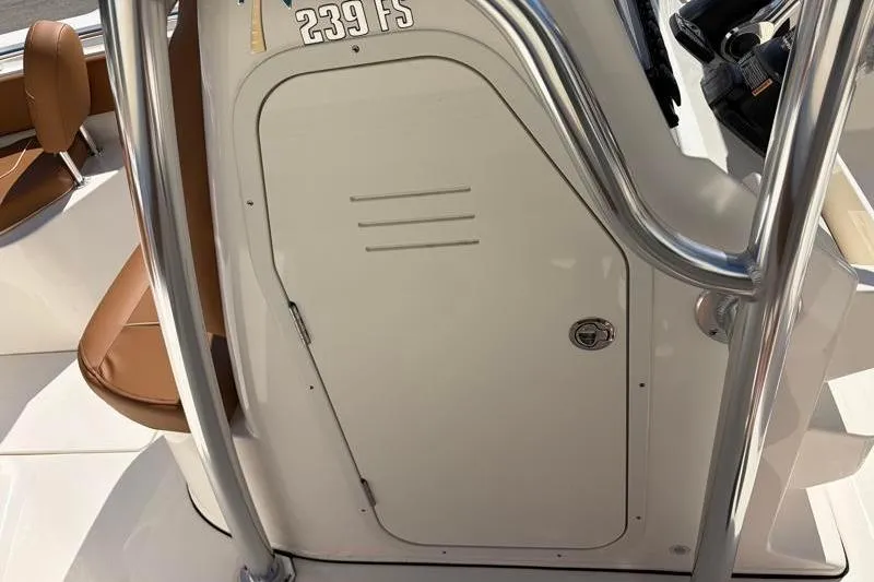 Slide: The Image of 2025 Key West 239 FS boat interior with brown seating and storage compartment. - 34