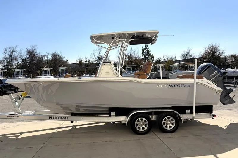 Slide: The Image of 2025 Key West 239 FS boat on trailer, side view, outdoors. - 4