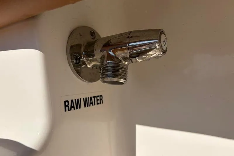 Slide: The Image of Key West 239 FS 2025 boat raw water outlet, chrome finish, close-up view. - 41