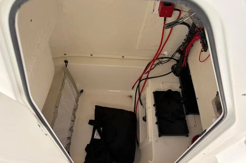 Slide: The Image of Storage compartment of 2025 Key West 239 FS boat with wiring and equipment. - 42