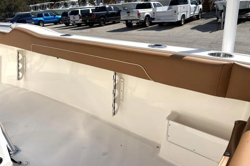 Slide: The Image of 2025 Key West 239 FS boat interior with tan upholstery and rod holders. - 43