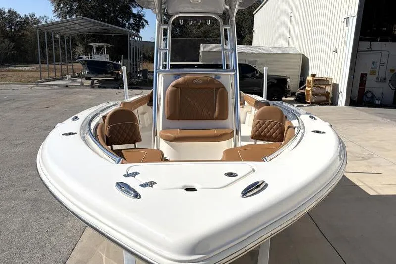 Slide: The Image of 2025 Key West 239 FS boat with tan seating, docked outdoors. - 6