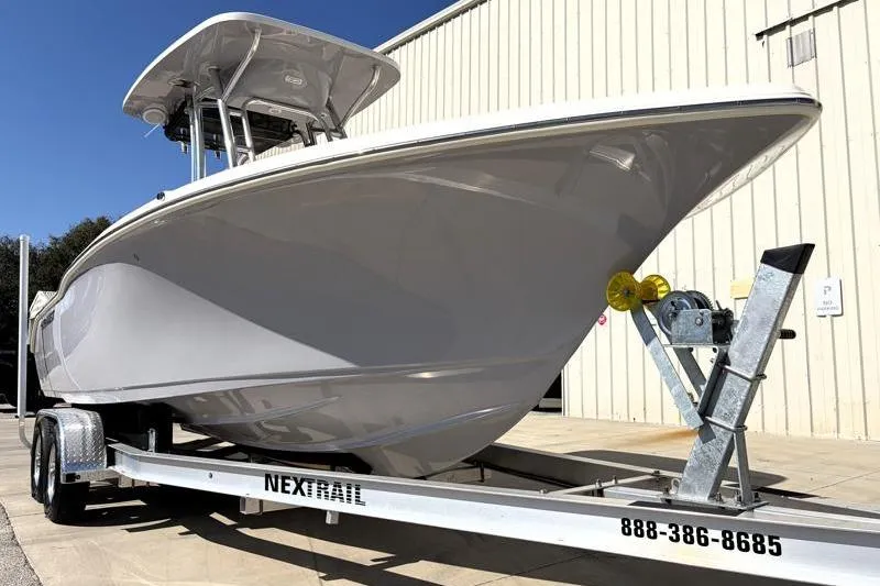 Slide: The Image of 2025 Key West 239 FS boat on trailer, parked outdoors near a building. - 8