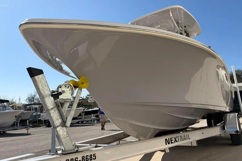 Slide: The Image of 2025 Key West 239 FS boat on trailer under clear blue sky. - 9