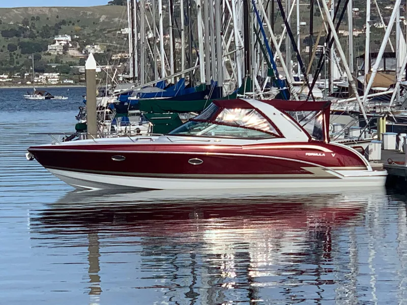 The Image of 2012 Formula 350 Sun Sport boat docked in marina, featuring sleek red and white design. - 0