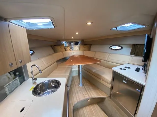 Slide: The Image of Luxurious interior of 2012 Formula 350 Sun Sport boat with seating, kitchenette, and skylights. - 16